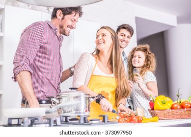 Woman Cooking At Home And Laughing With Her Friends - Home Party, Housewife Preparing Dinner For Her Guests