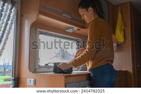 Woman cooking inside a motorhome
