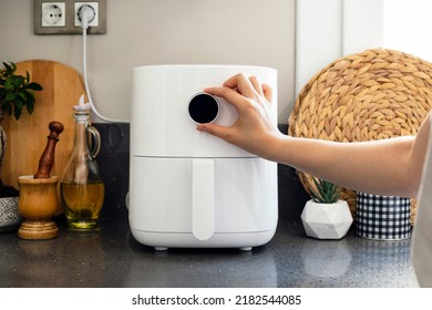  Woman cooking with modern Air fryer - Shutterstock ID 2182544085