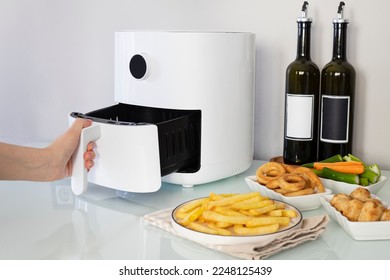 Woman cooking with modern Air fryer - Shutterstock ID 2248125439
