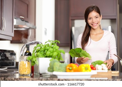 Woman Cooking In New Kitchen Making Healthy Food With Vegetables. Young Multicultural Caucasian / Asian Chinese Woman In Her Twenties.