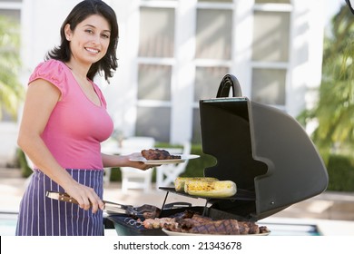 Woman Cooking On A Barbeque