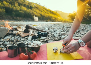 Woman Cooking On Camp Fire. Wild Nature Resting. Cutting Mushrooms