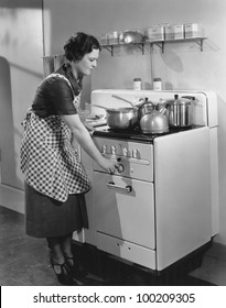 Woman Cooking On Stove