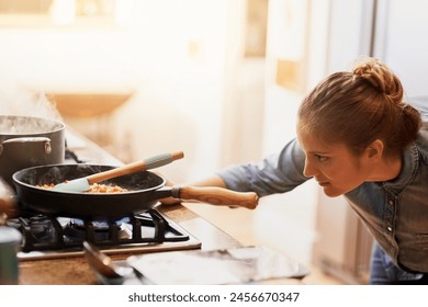 Woman, cooking and pan of food on gas stove in kitchen, preparing meal and culinary at home. Female cooker, frying and heating healthy dish with nutrient, protein and organic for dinner or supper