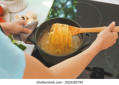 Woman Cooking Pasta On Electric Stove