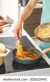 Woman Cooking Pasta On Electric Stove