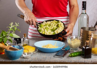 Woman Cooking Pasta With White Cream Sauce At Home In The Kitchen