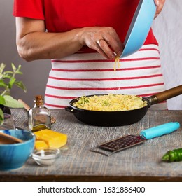 Woman Cooking Pasta With White Cream Sauce At Home In The Kitchen