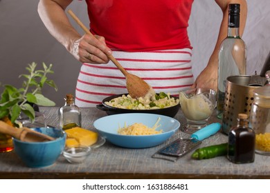 Woman Cooking Pasta With White Cream Sauce At Home In The Kitchen