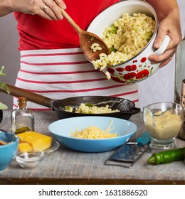 Woman Cooking Pasta With White Cream Sauce At Home In The Kitchen