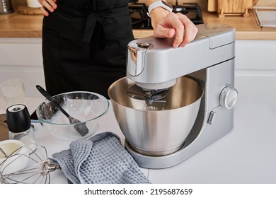 Woman cooking at preparing food, using food processor, Modern appliance for cooking