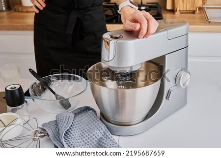 Woman cooking at preparing food, using food processor, Modern appliance for cooking