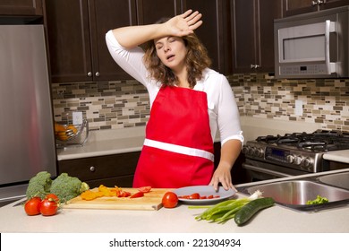 woman cooking with raw vegetables in the kitchen - Powered by Shutterstock