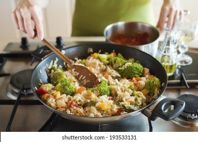 Woman Cooking Risotto On Stove Close Up Shoot