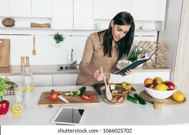 Woman cooking vegetable summer salad in the home kitchen