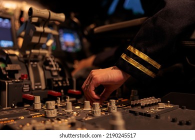 Woman Copilot Using Control Panel Command On Dashboard Navigation To Fly Ariplane In Cockpit. Female Airliner Flying Plane In Cabin With Power Engine And Switch Lever. Close Up.