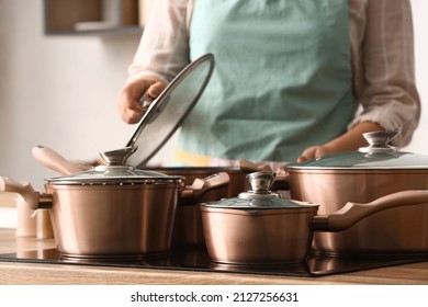 Woman with copper pots cooking in kitchen, closeup - Shutterstock ID 2127256631