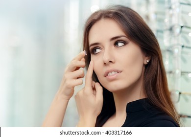 Woman With Cosmetic Colored Contact Lens In Optical Store - Close Up Of A Girl Trying On Beauty Medical Contact Lenses
