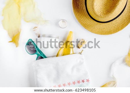 Woman cosmetic set with sun protection lotion white background top view