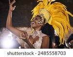 Woman, costume and carnival as samba dancer with music, parade and energy for celebration. Performance, happy and traditional outfit at night party with culture and crowd for event in rio de janeiro