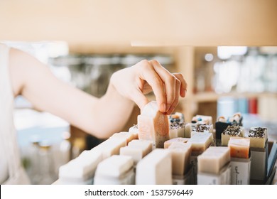 Woman With Cotton Bag Buying Personal Hygiene Items In Zero Waste Shop. Eco Organic Cosmetics. Girl Choose Toiletries Products In Plastic Free Store. Minimalist Lifestyle. Shopping At Local Businesses