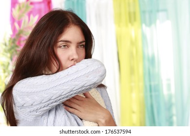 Woman Coughing In The Crook Of Her Arm