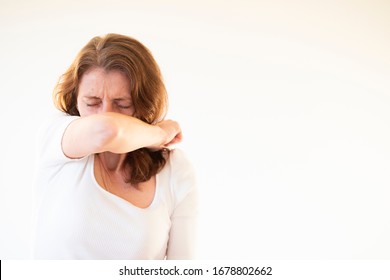 Woman Coughing Or Sneezing In Her Elbow