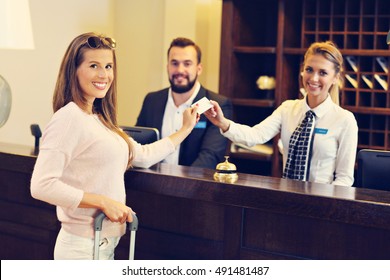 Woman At Counter In Hotel