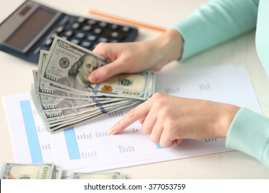 Woman Counting Money At The Table