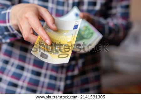 Woman counts money. female hands hold cash banknotes denominations of 200 euro currency. business man rich female hands hold and count cash banknotes euros or paper banknotes