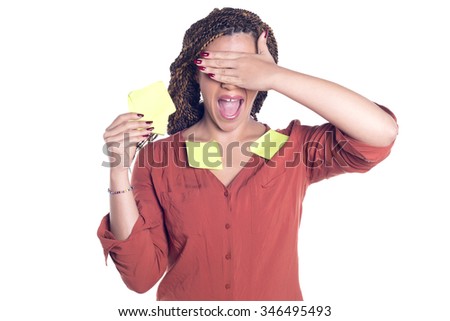 Woman covered with post it notes, laughing, confused, covering her eyes, isolated on white