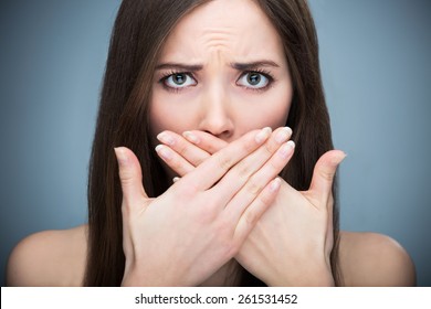 Woman covering mouth
 - Shutterstock ID 261531452