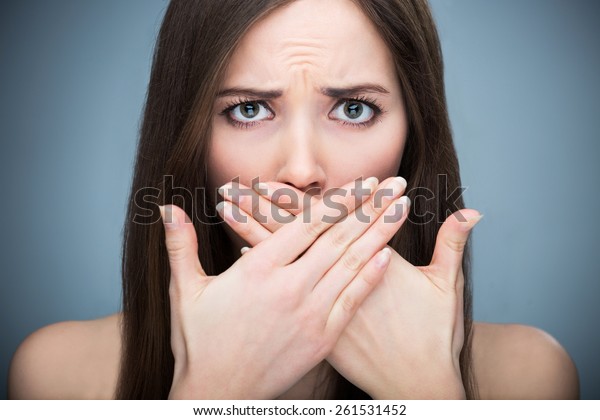 Woman covering\
mouth\
