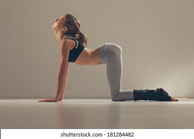 Woman In The Cow Yoga Pose.