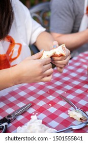 Woman Cracking Open A Steamed Crab Claw, In A Seafood Cookout Concept, With Space For Text On Top And Bottom