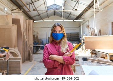 Woman As A Craftsman Apprentice With Face Mask Because Of Covid-19 In The Workshop