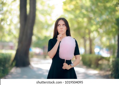 Woman Craving Sugary Cotton Candy Dessert Treat. Sweet Girl Counting Calories And Feeling In Doubt About Eating Street Food
