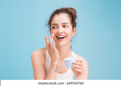 Woman With Cream On Blue Background 