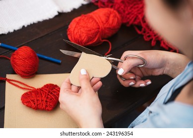 Woman Creating Red Woolen Heart