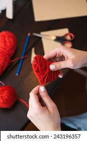 Woman Creating Red Woolen Heart