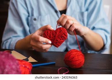 Woman Creating Red Woolen Heart