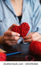 Woman Creating Red Woolen Heart