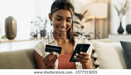 Woman, credit card and phone on sofa, smile or reading with cybersecurity, fintech app or bank info in home. Girl, smartphone and payment for password, budget or online shopping on e commerce website