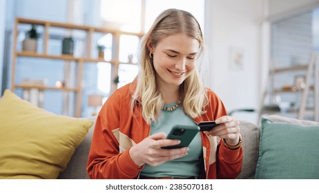Woman, credit card and phone for online shopping in home with digital payment, fintech and finance of money. Happy person on sofa for mobile banking, ecommerce and password for sales on financial app