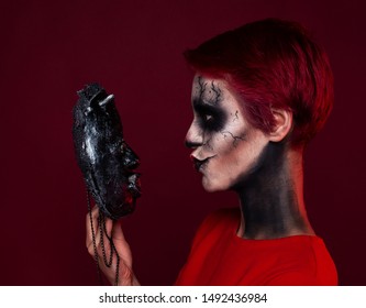 Woman With Creepy Makeup Stands In Front Of The Mask And Tries To Kiss Her. Crazy Love Concept