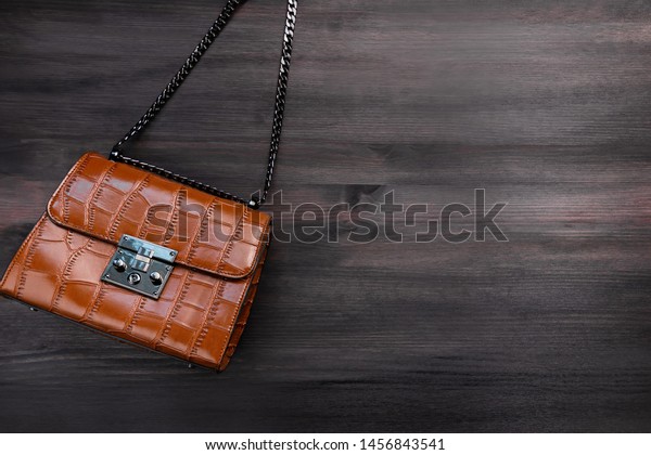 Woman crocodile leather purse or\
handbag on chain closeup, casual style, top view, copy\
space