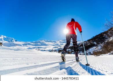 Woman cross country skie on a sunny winter morning in French Alps, 3 Valleys.