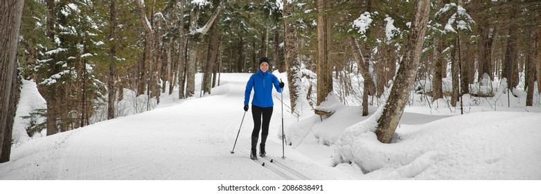 Woman Cross Country Skiing Classic Style Nordic Skiing In Forest. Active Girl In Winter Wonderland Doing Fun Winter Sport Activity In The Snow On Cross Country Ski In Beautiful Nature Landscape.