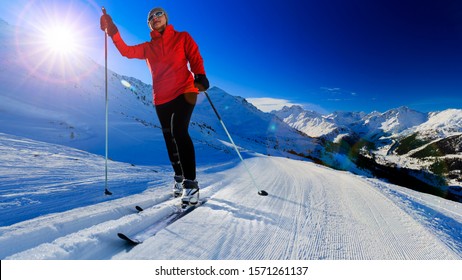 Woman cross country skiing on a sunny winter morning in Swiss Alps, 